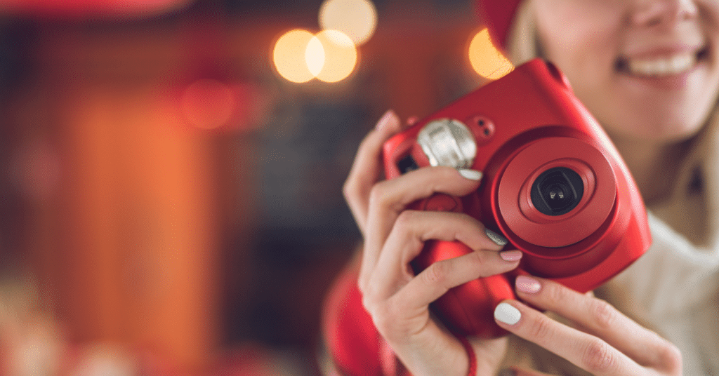 Smiling teen girl with Polaroid camera